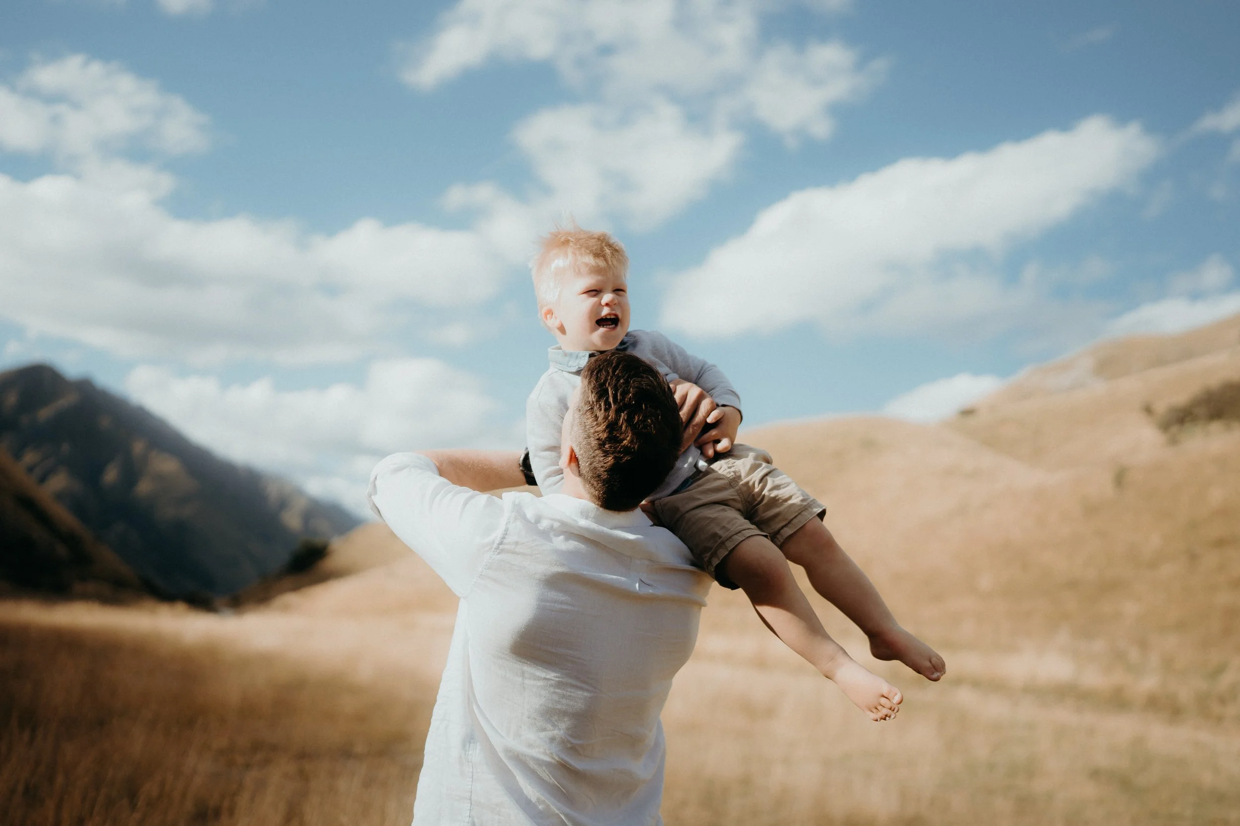 Action shot of Dad swinging son in air at Moke Lake