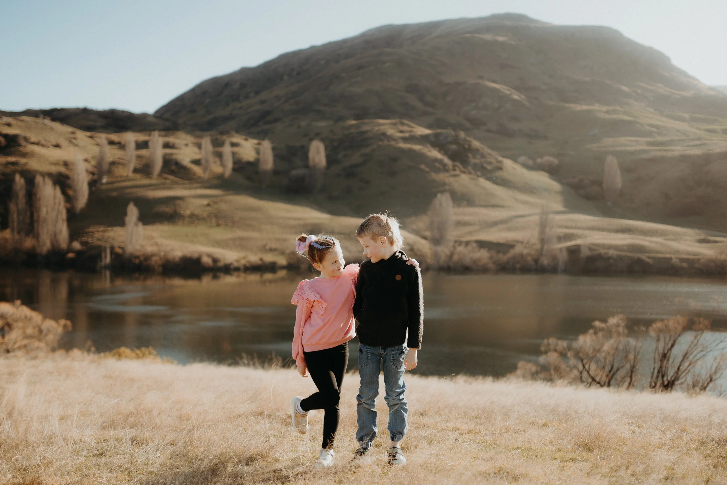 Brother and sister posing in front of Lake Johnson
