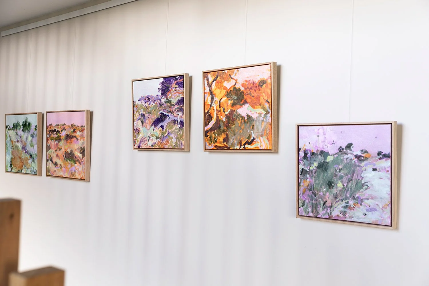 Small original framed artworks hanging together on the wall at exhibition at Lon Retreat by Belinda Marshall
