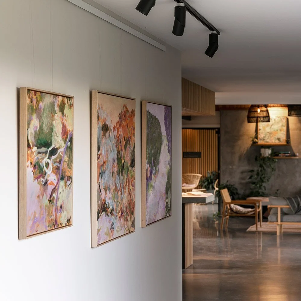 Original framed abstract paintings hanging in exhibition on wall at Lon Retreat by Belinda Marshall