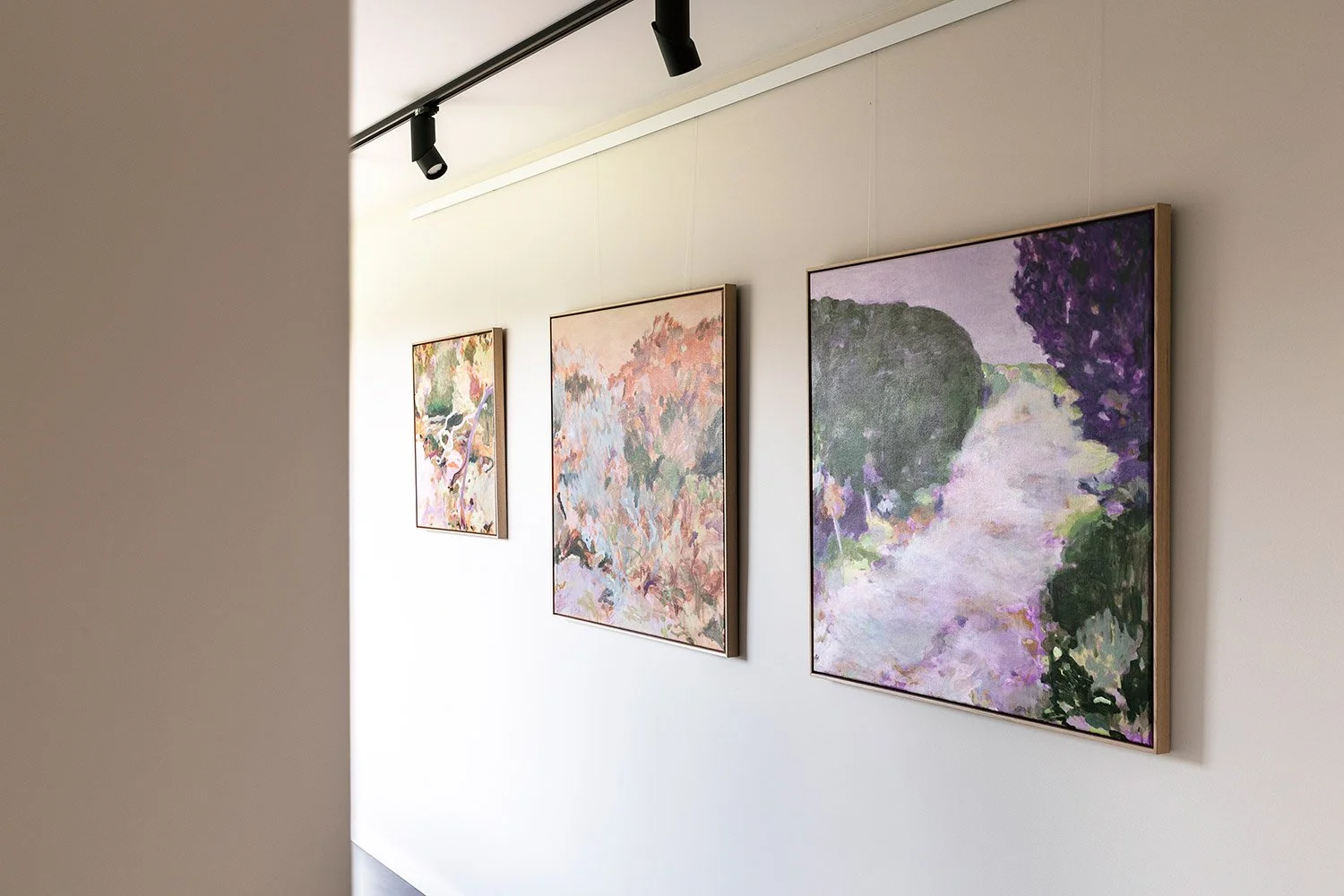 Original framed abstract paintings hanging in exhibition on wall at Lon Retreat by Belinda Marshall
