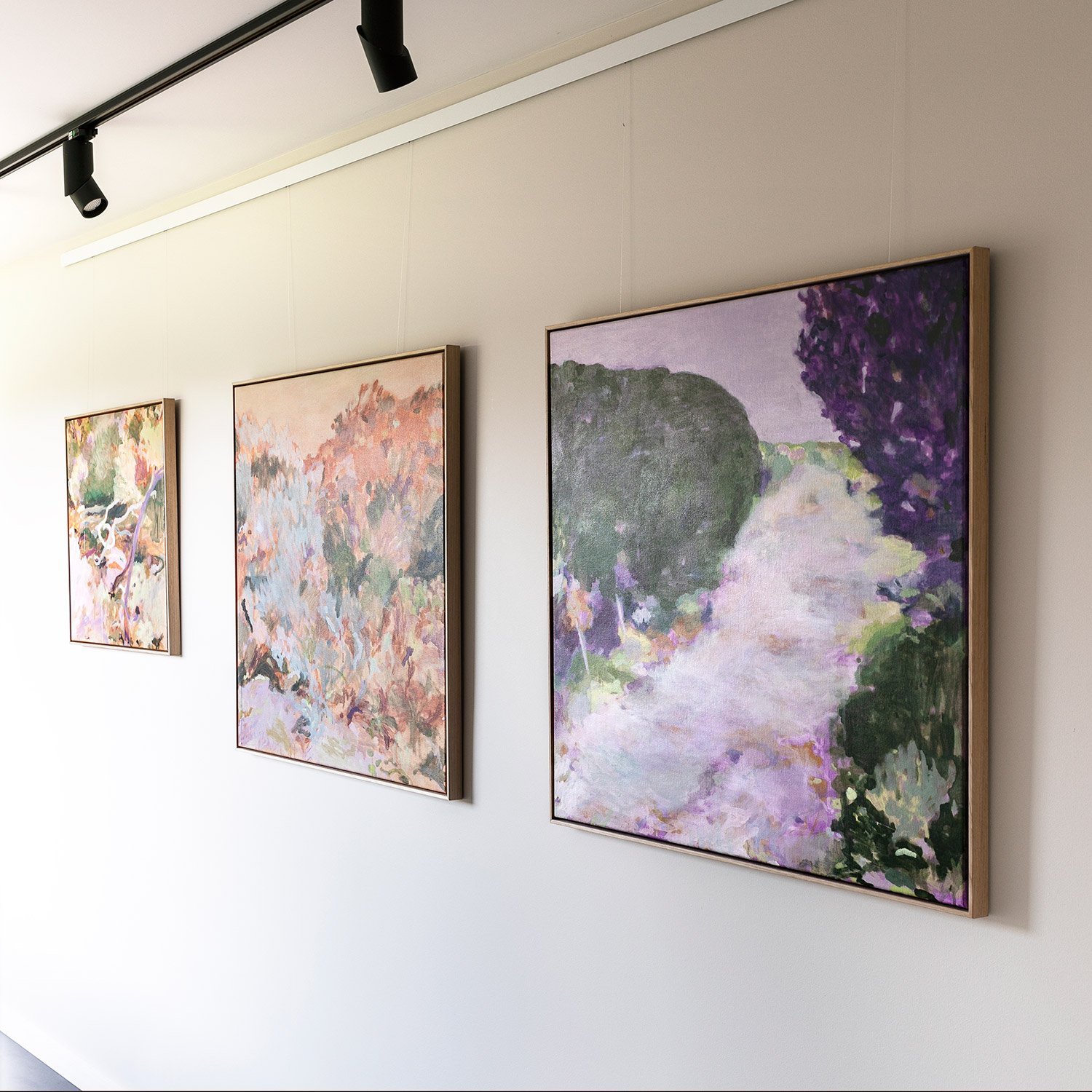 Original framed abstract paintings hanging in exhibition on wall at Lon Retreat by Belinda Marshall