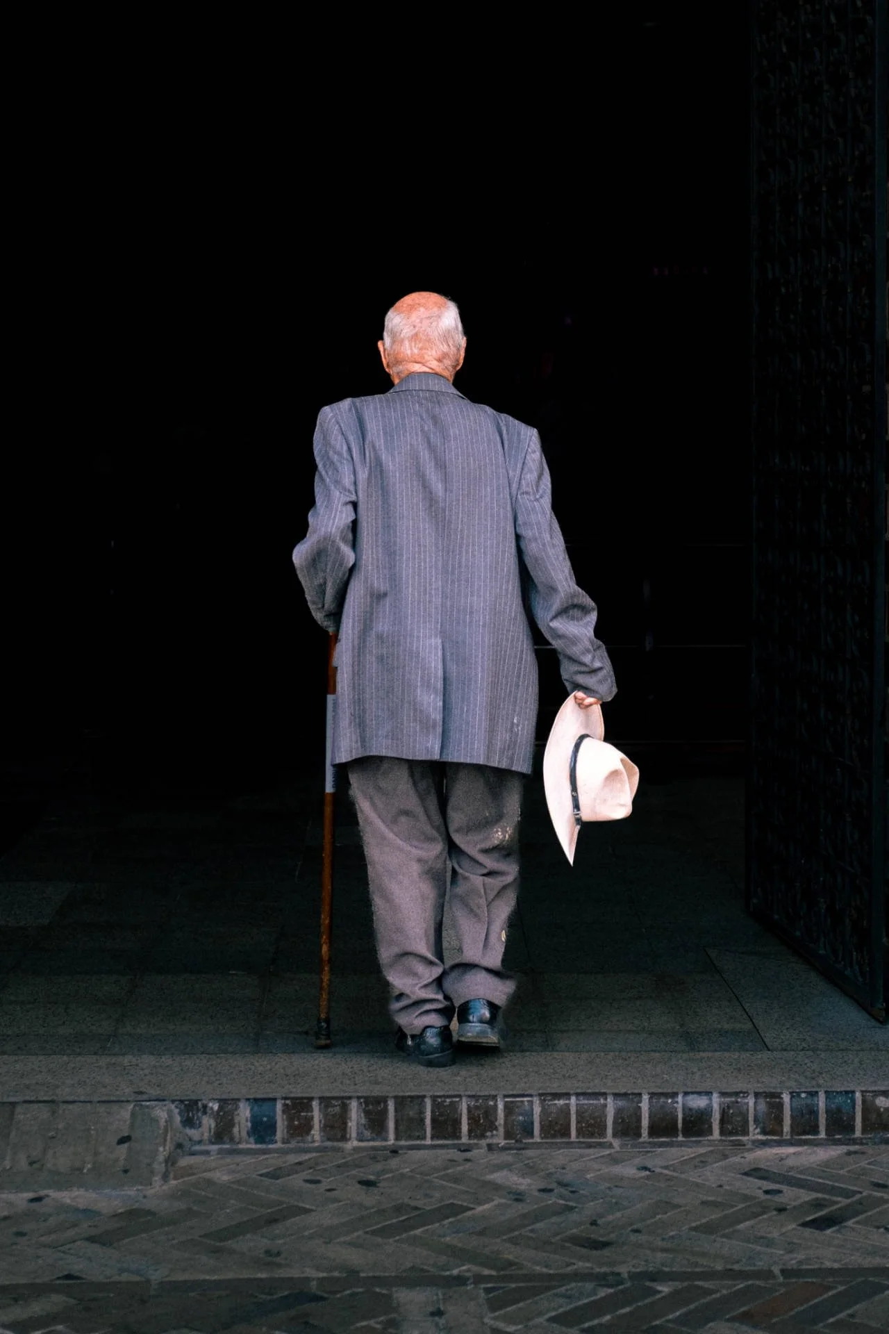 A gentleman removes his hat before entering church. It's time to talk to God.