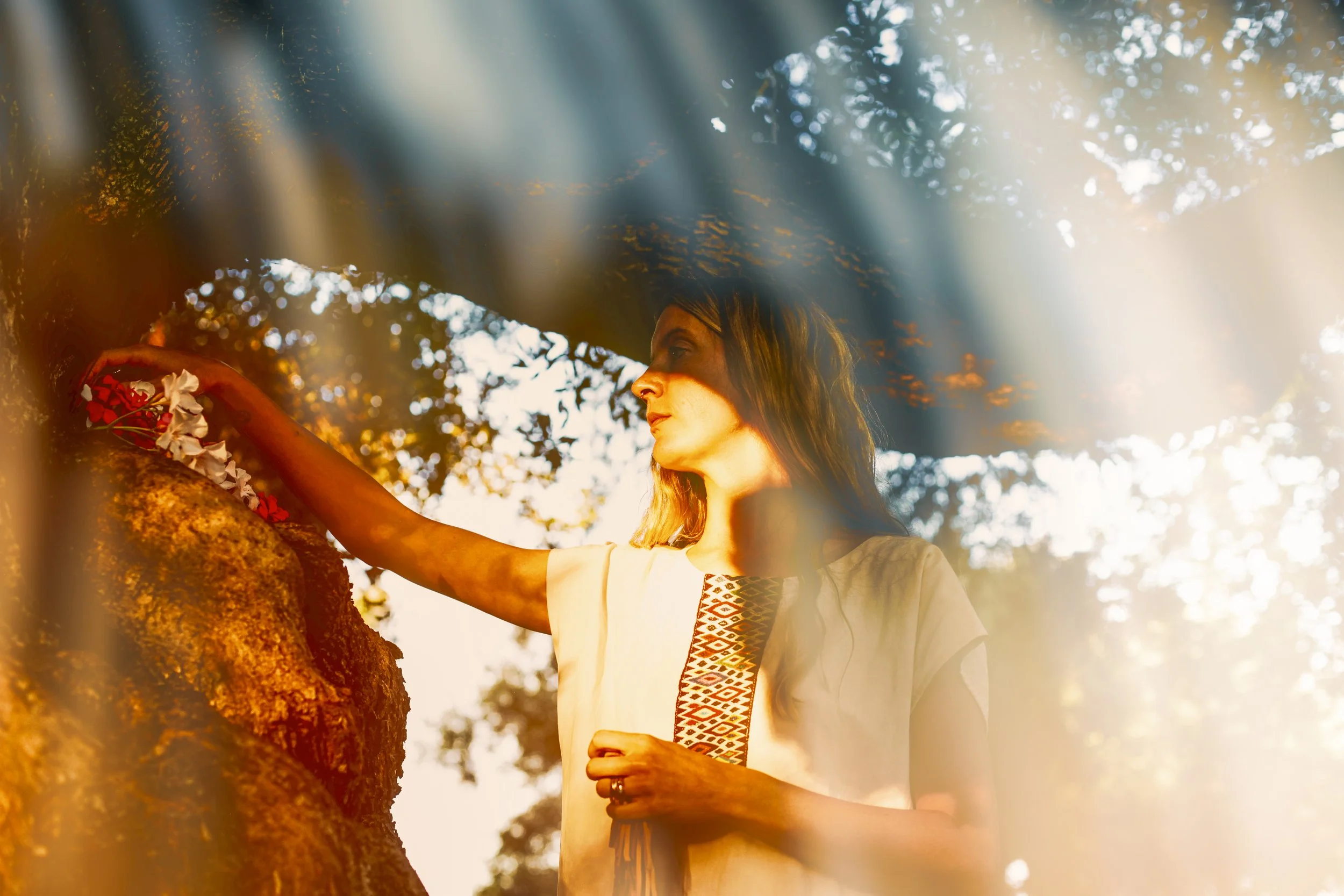 medicine woman making offering to tree