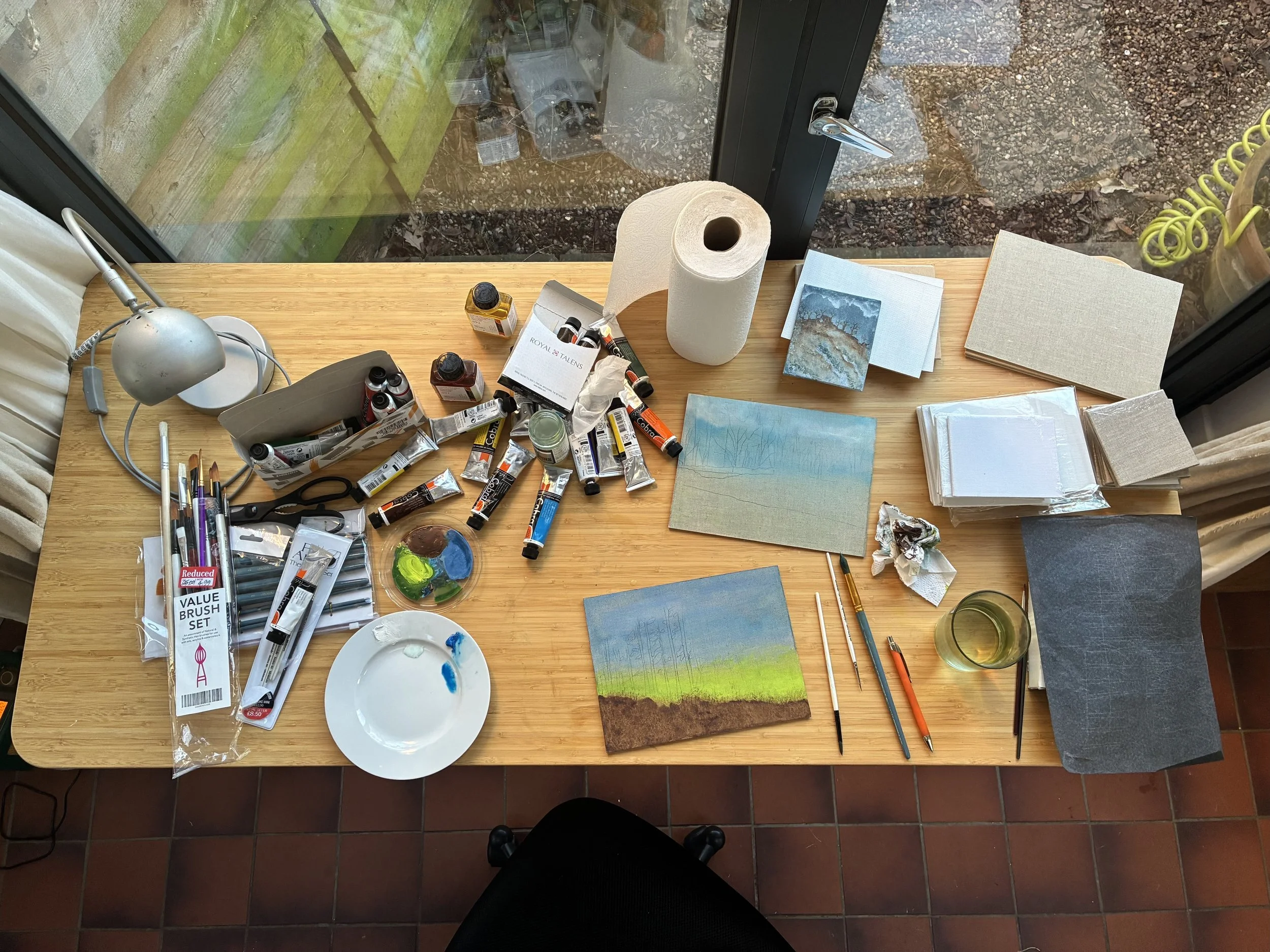 table with canvases and paints
