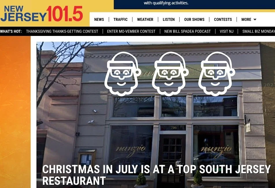 The image shows the exterior of a building with three illuminated Santa Claus face signs above the entrance. The building has large windows and there is a sign with the word 'Yungio' on the front.