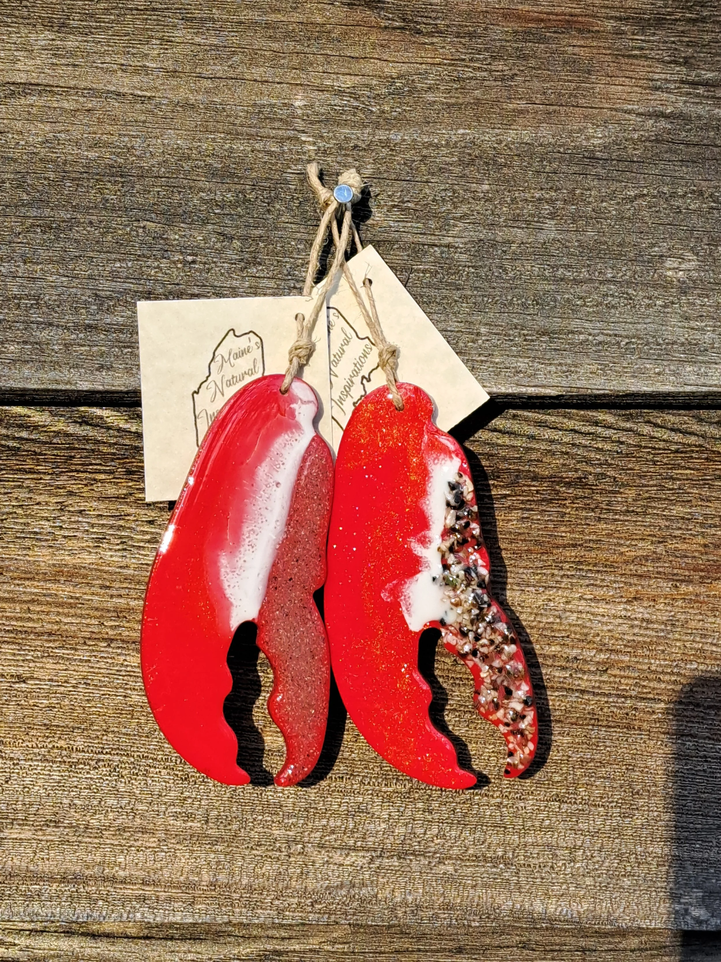 Lobster claw ornaments made with different Maine beach sand along the edge.