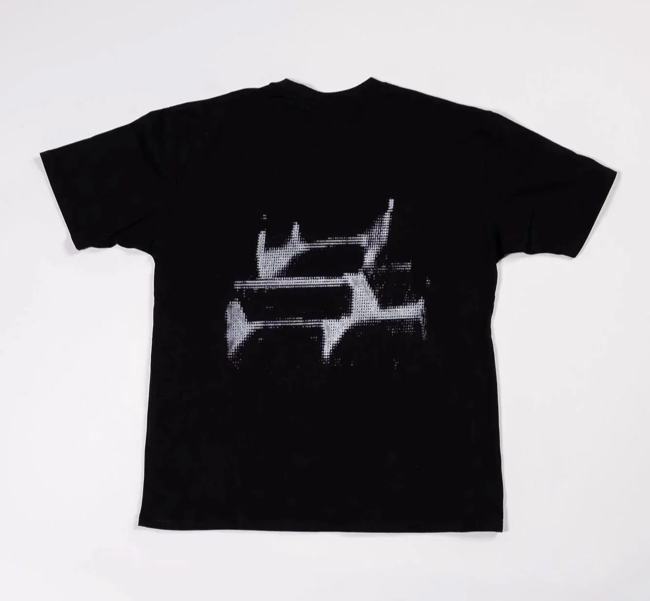 Black t-shirt with small silver angular holographic-style halftone ‘HOM’ logo on chest and large silver holographic-style halftone ‘HOM’ logo across upper back