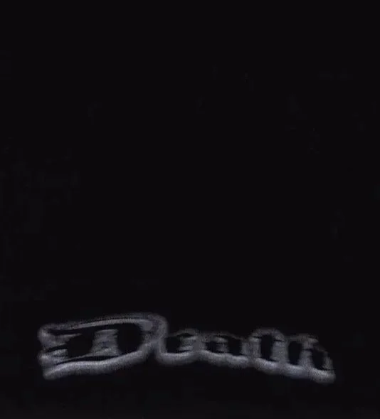 Close up of black t-shirt with grey airbrushed-style ‘Death’ gothic script text print near bottom hem