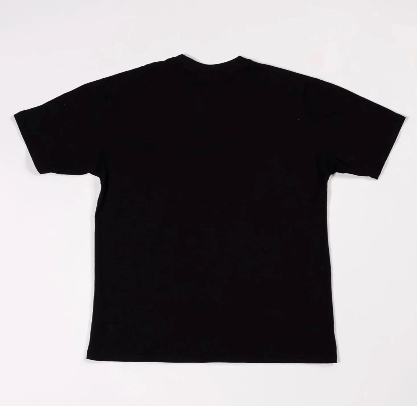 Back of black t-shirt with grey airbrushed-style ‘Death’ gothic script text print near bottom hem