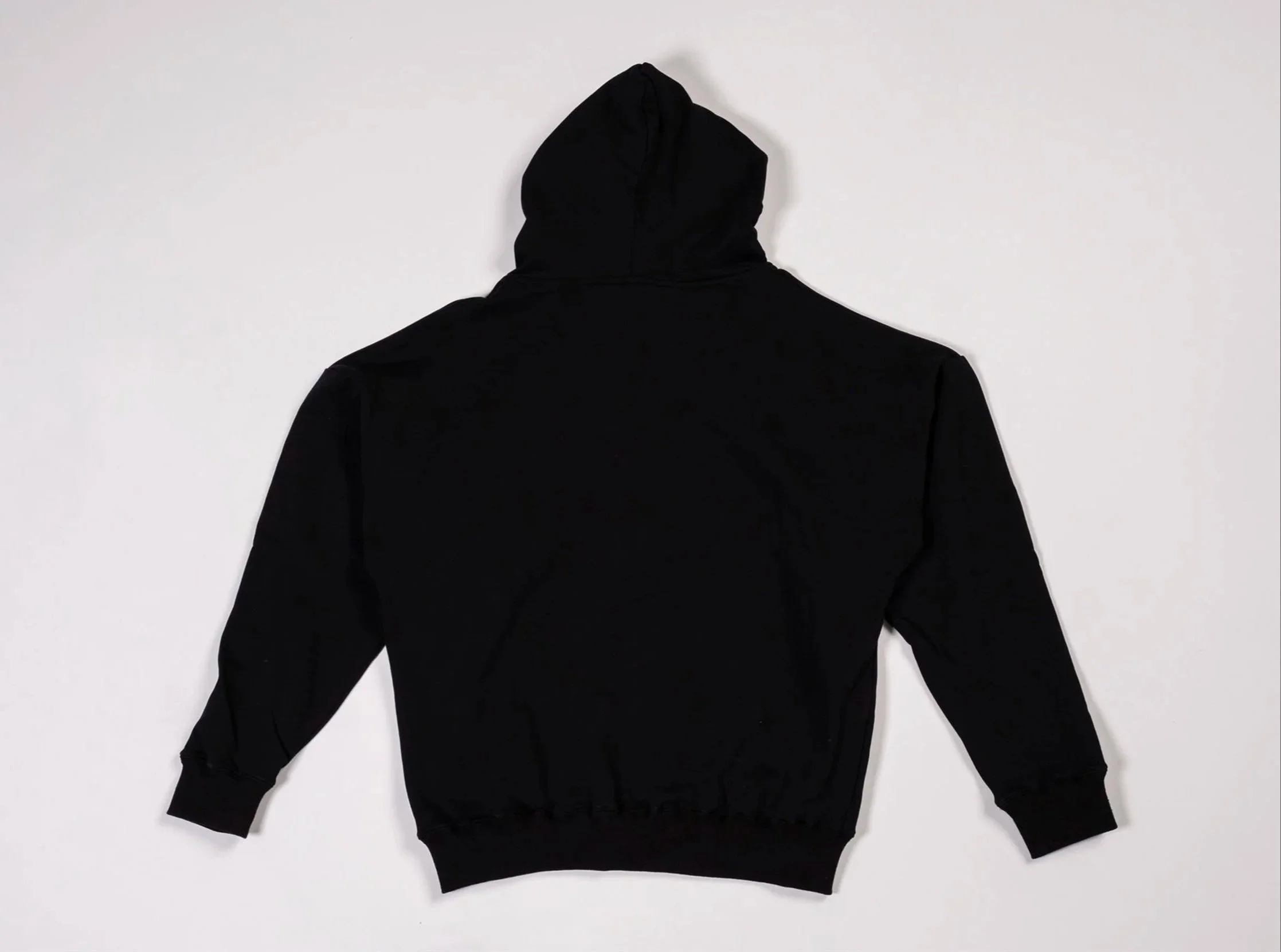 Back of black pullover hoodie with small debossed ‘II’ logo below hood on front