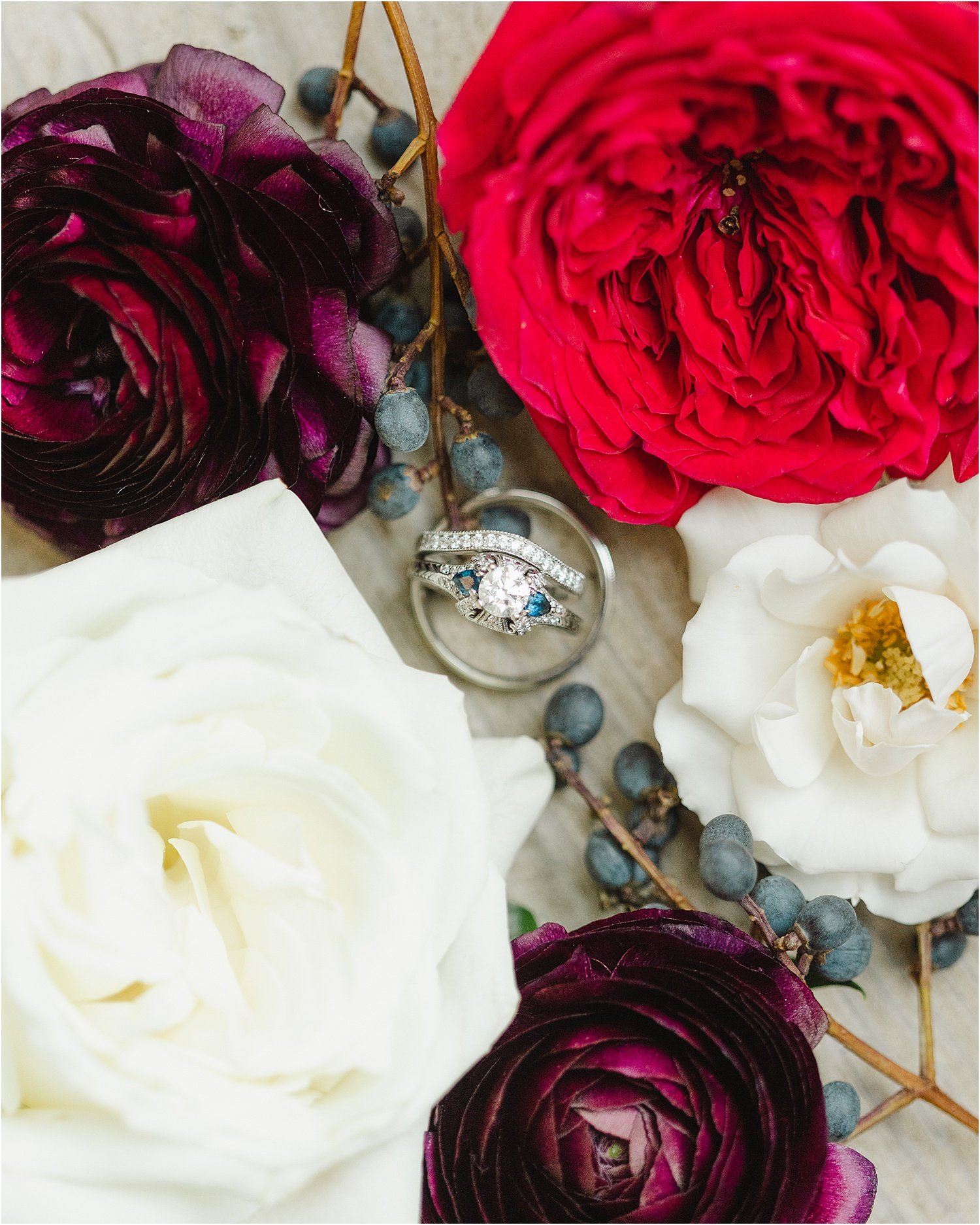 Unique Wedding Rings Surrounded by Florals and Winter Berries