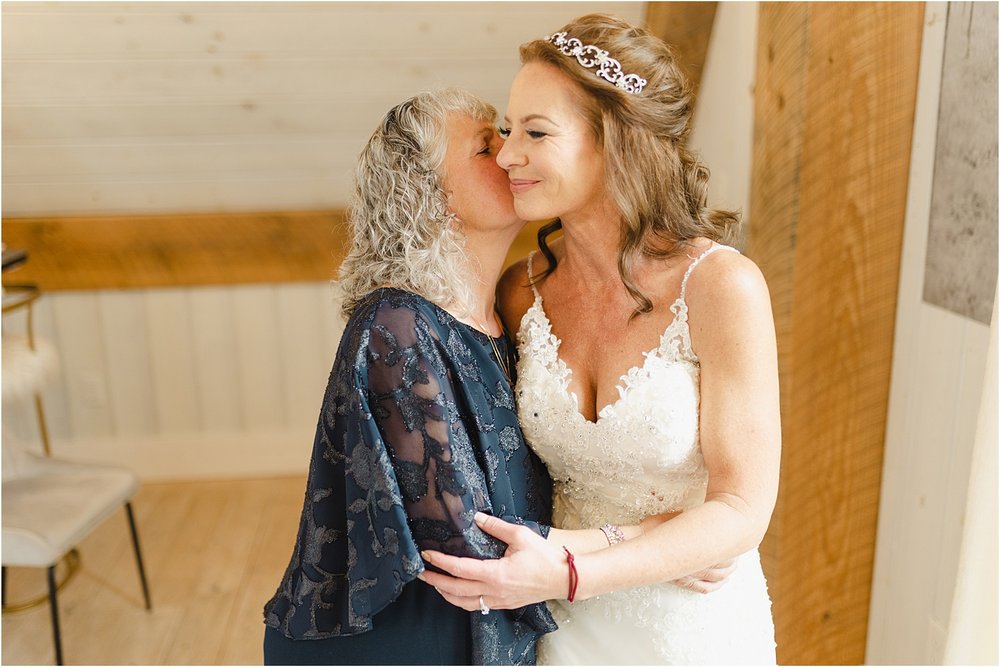 Photo of Mother Kissing Her Daughter at Wedding