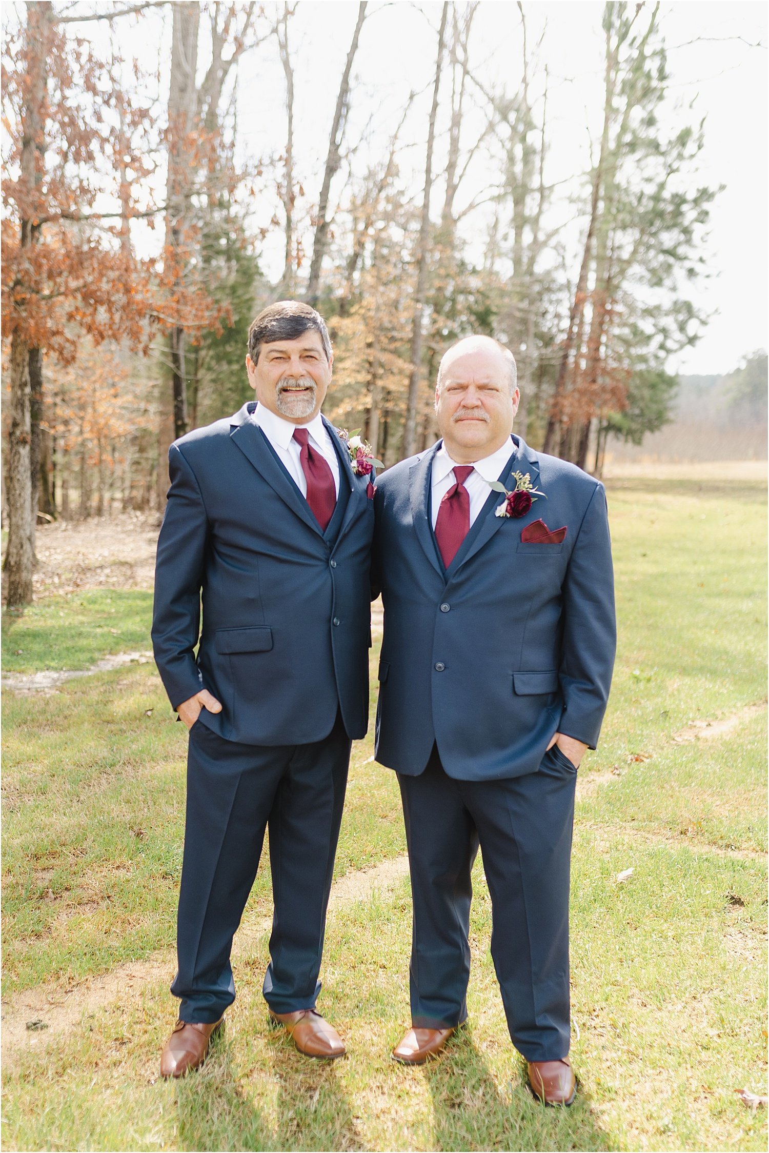 Photo of Groom and Best Man in Navy Suits with Red Ties