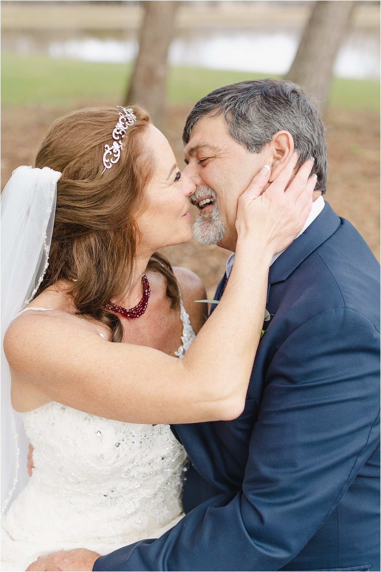 Photo of Bride and Groom Kissing While Swinging