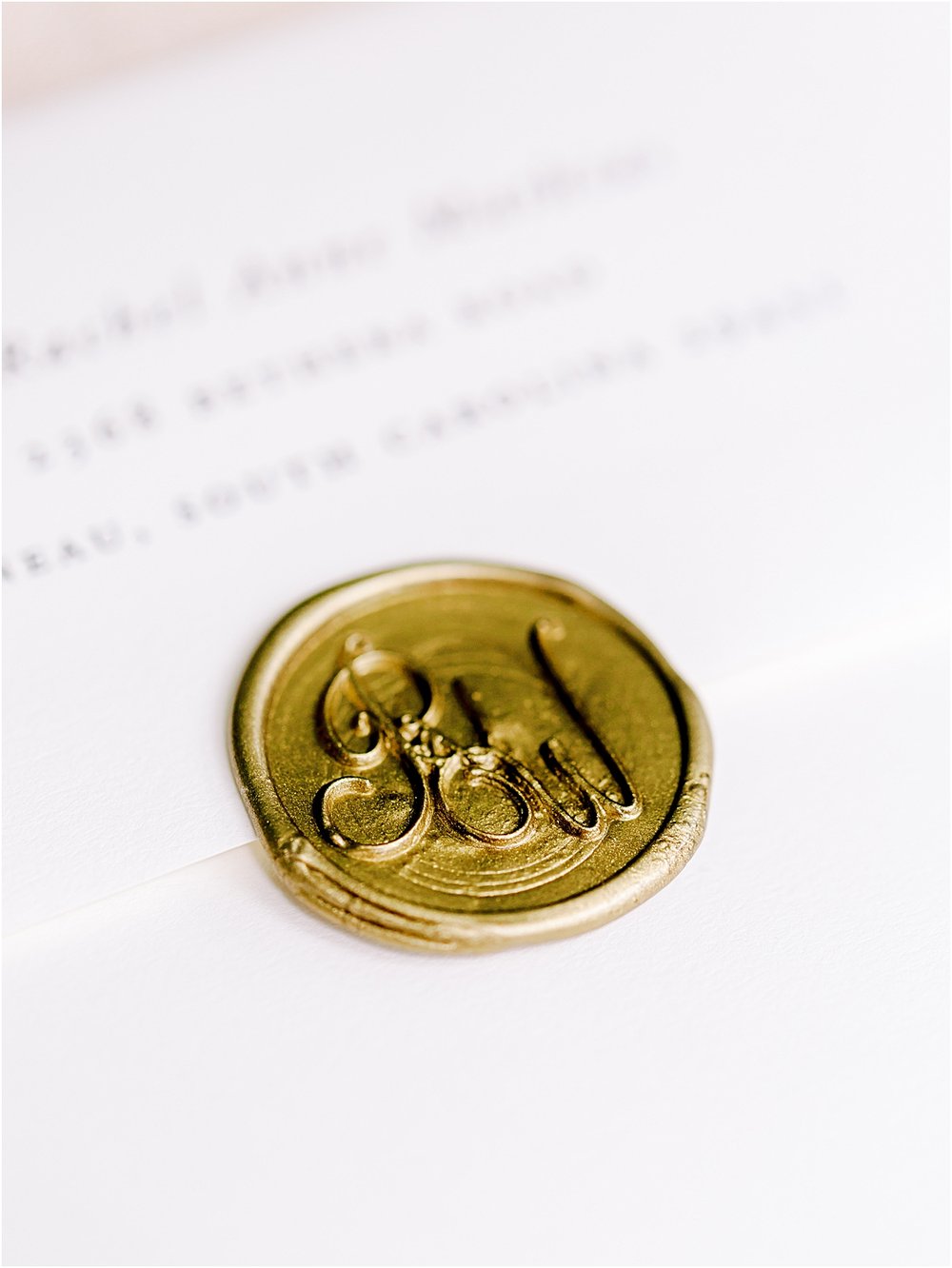 Gold monogrammed wax seal for wedding invitation suite