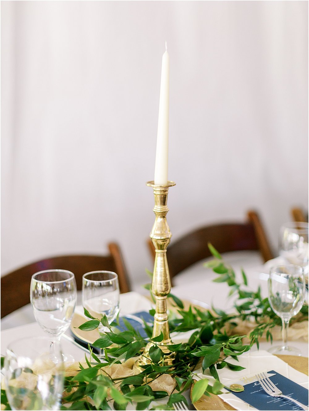 Gold candle stick with greenery 