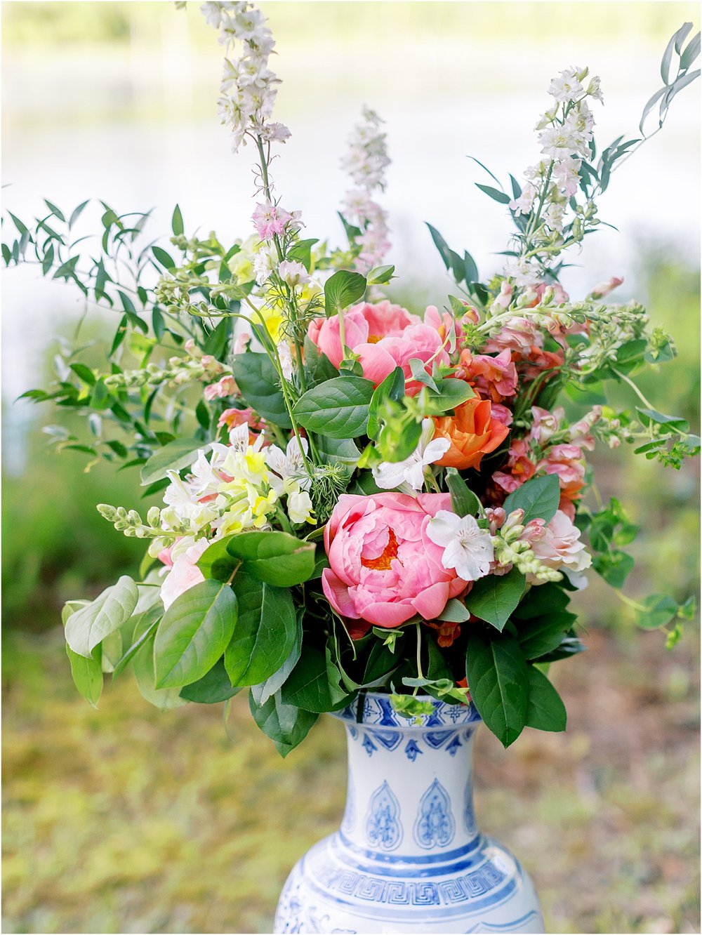Blue and white vase with pink peonies floral arrangement