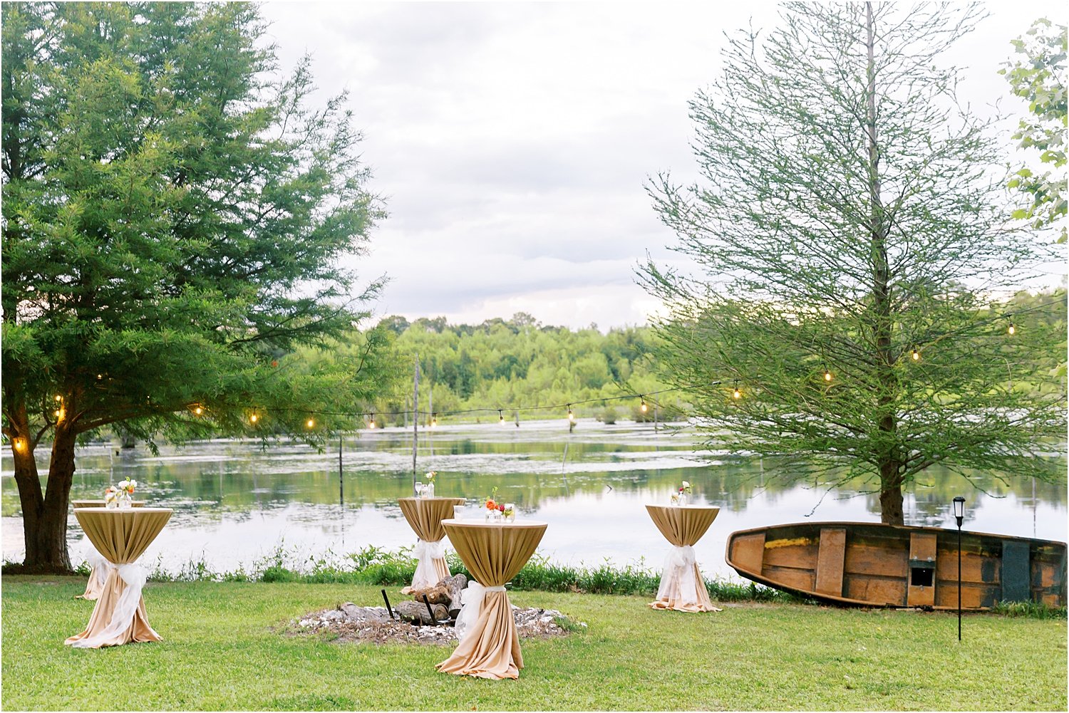 Waterfront cocktail hour with neutral table linens and pops of summer color