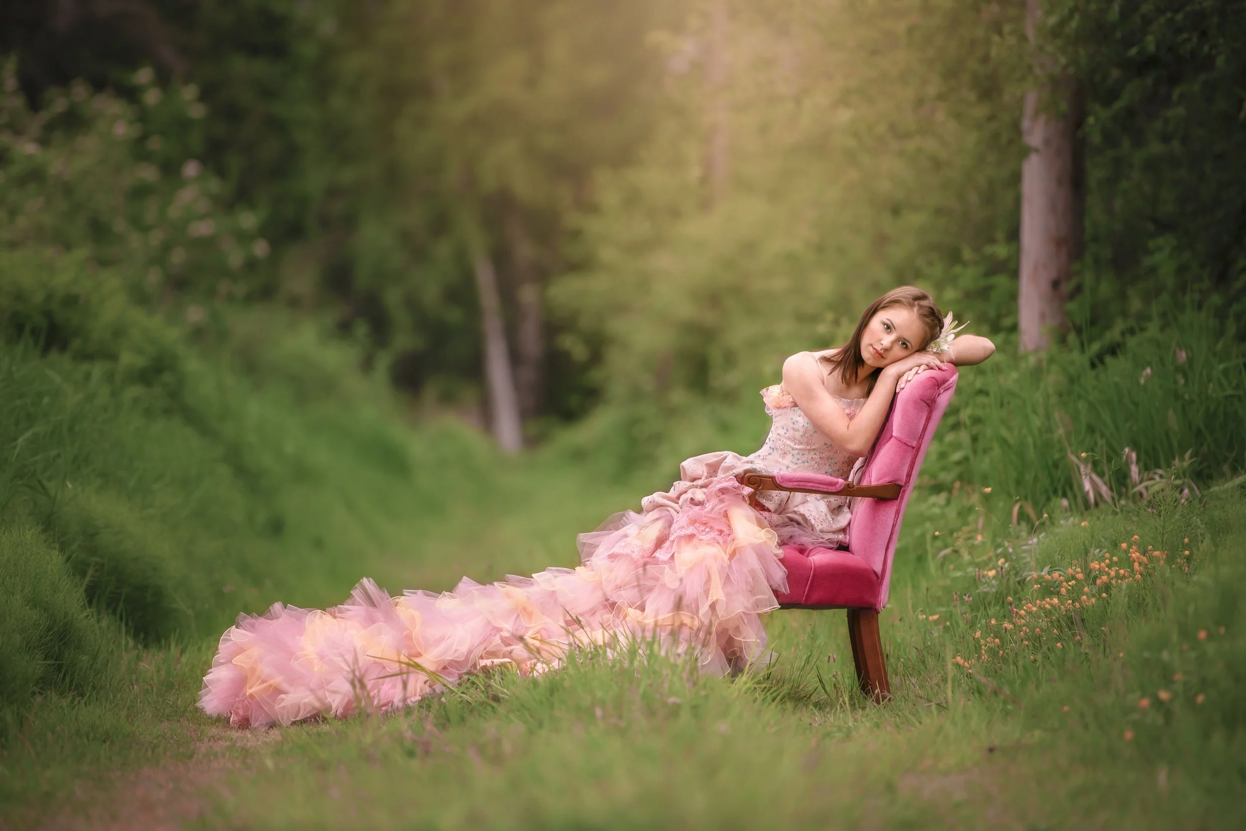 calgary children photographer girl sitting on pink chair in pink dress.jpg