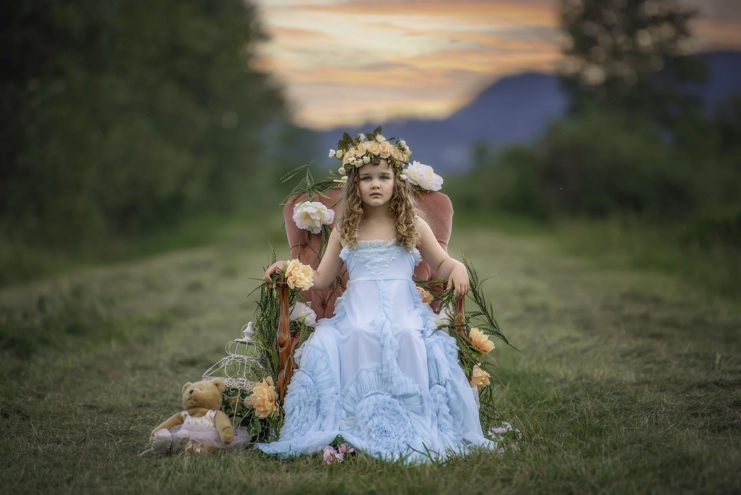 calgary children photographer Girl sitting on pink chair on path.jpg