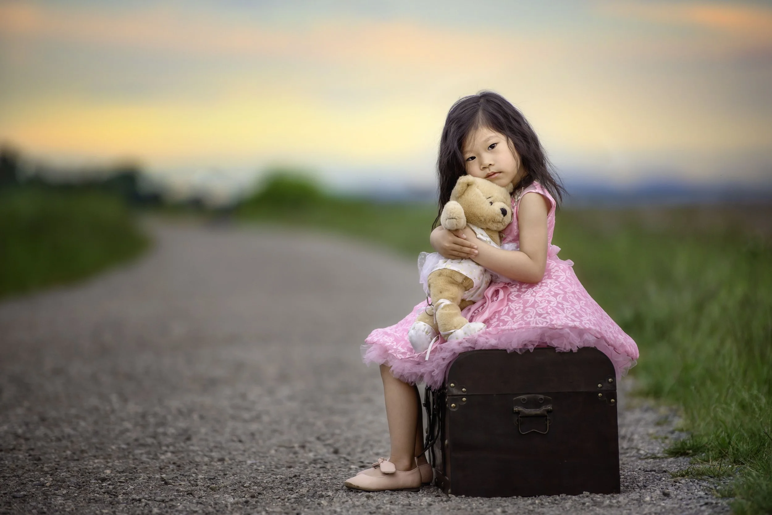 calgary children photographer Girl hugging stuffy on path at sunset.jpg