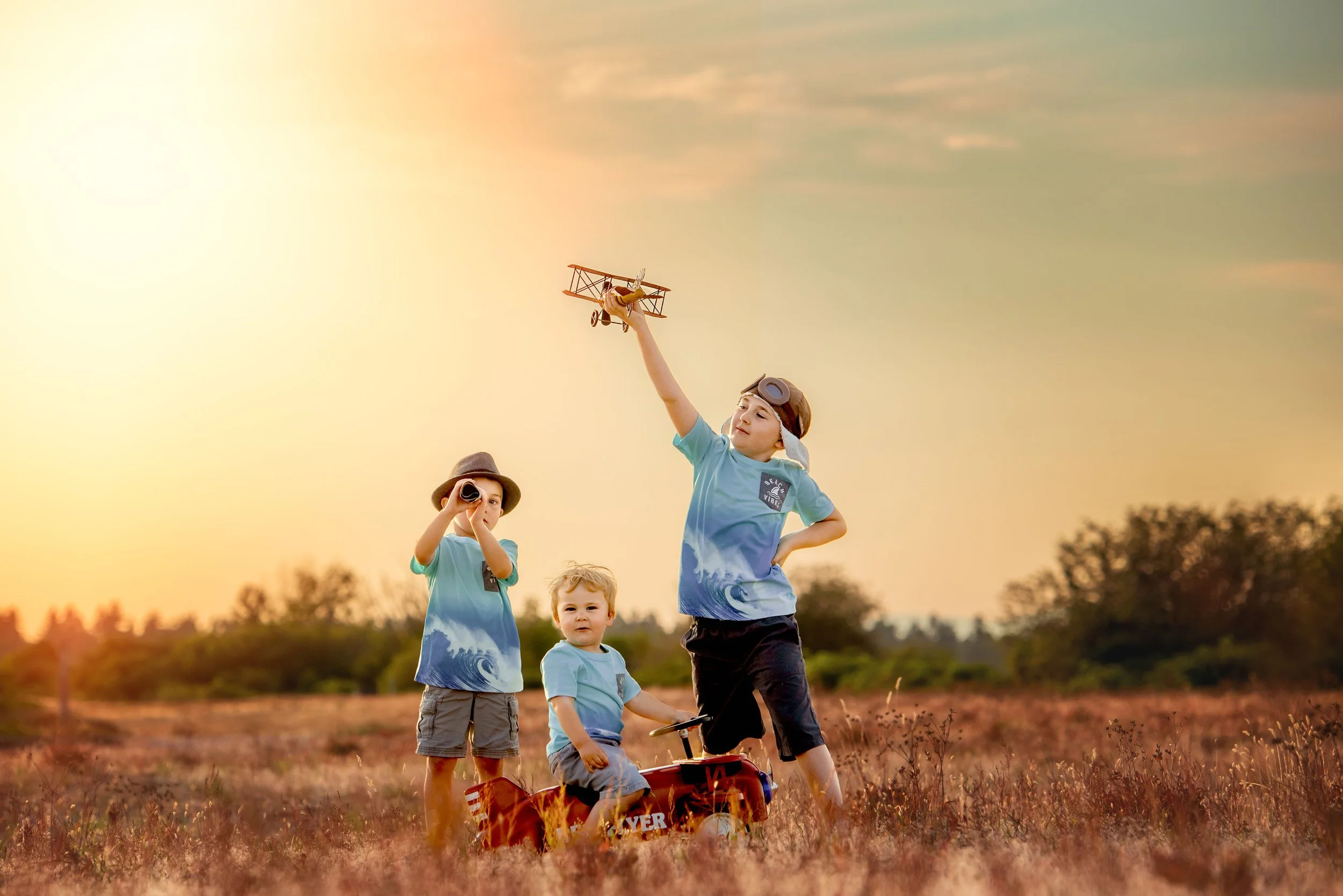 calgary children photographer boys playing with toys in field.jpg