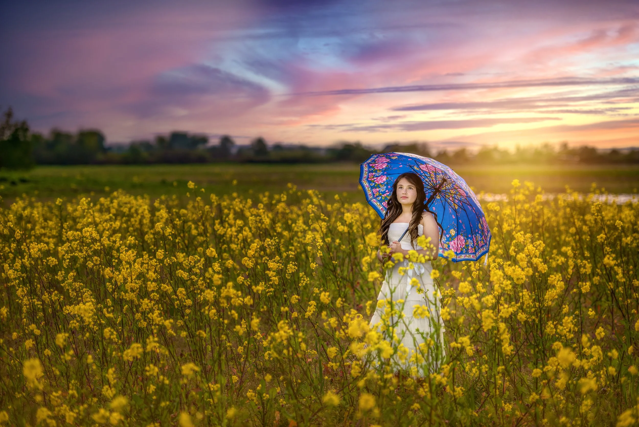 calgary children photographer girl holding floral umbrella in a field of wildflowers.jpg