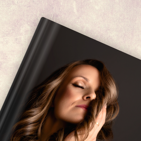 A clothing rack with various dresses and garments in different colors, styles, and lengths hanging on hangers.