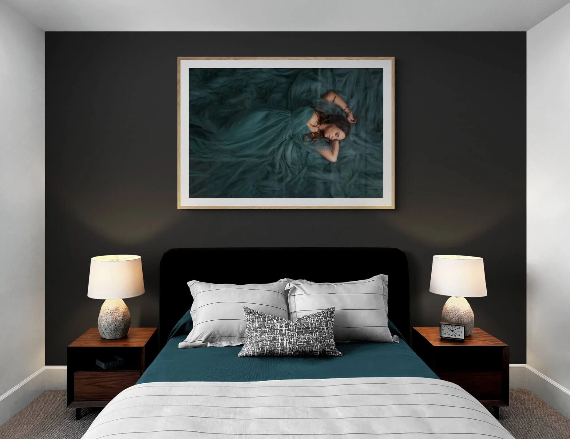 A woman dressed in a red strapless gown with ruffled fabric on the bodice, sitting on the floor against a brown background. She wears gold jewelry, including a wide choker, bracelets, and a headpiece resembling a crown or halo with radiating lines.