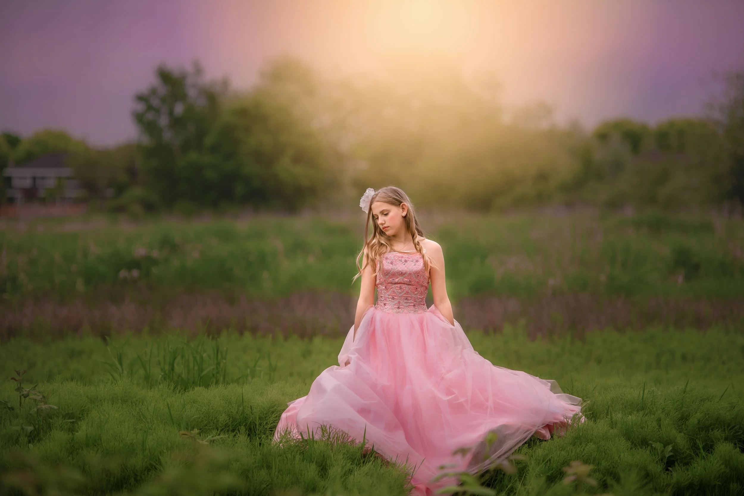 Calgary-family-photographer-girl in grass in pink dress.jpg