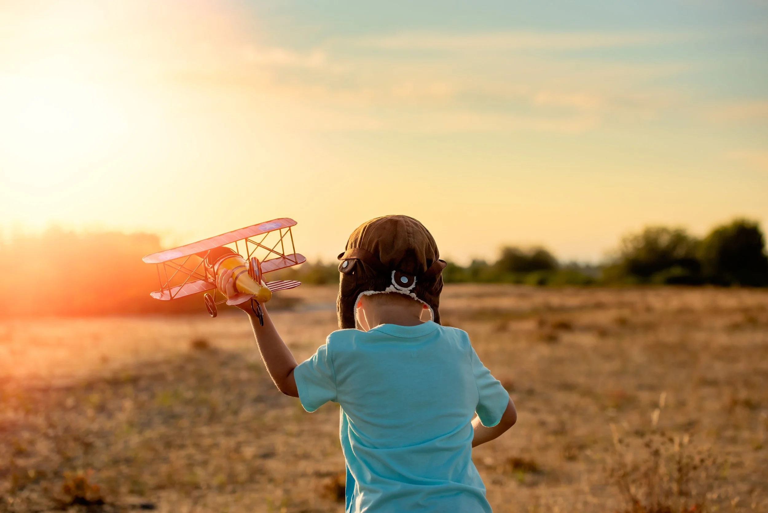 calgary children photographer boy playing with toy airplane.jpg