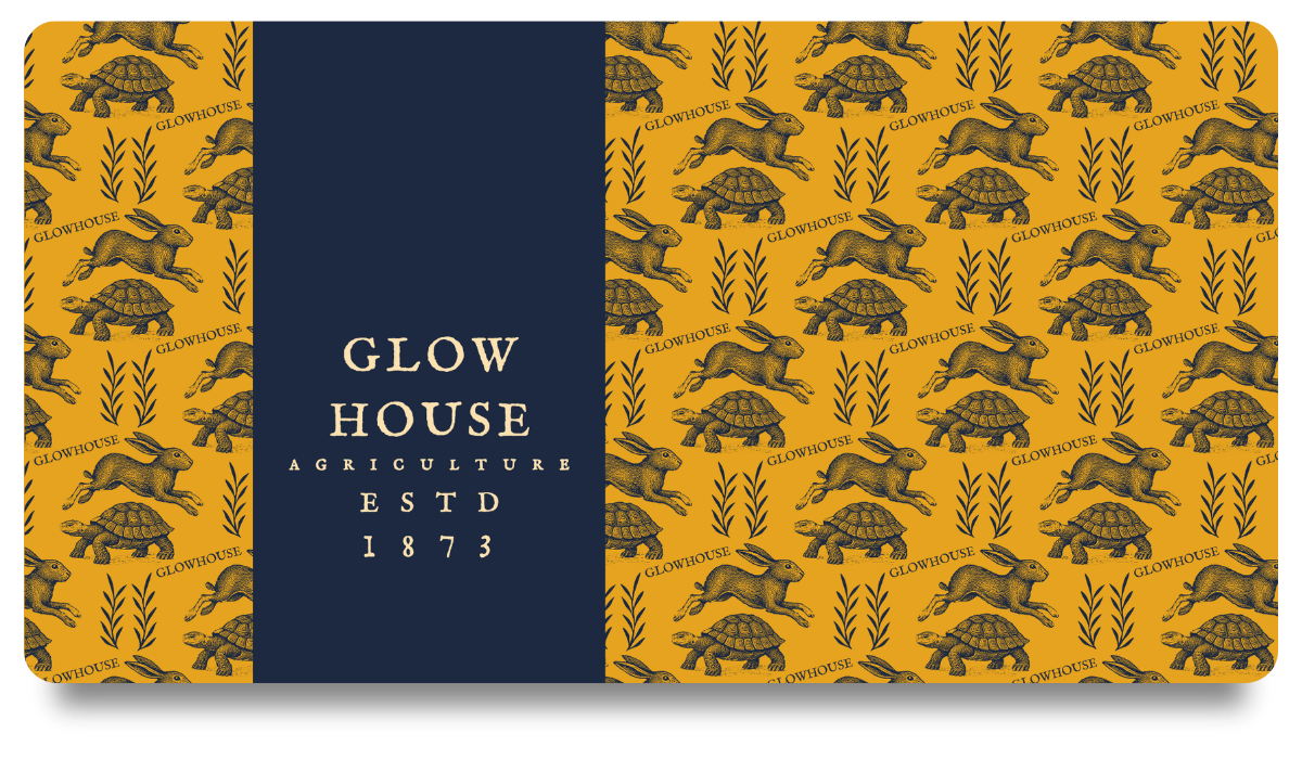 A packaging design for Glow House Agriculture with a yellow background, featuring illustrations of rabbits and turtles, and a navy blue label in the center with the text 'GLOW HOUSE AGRICULTURE ESTD 1873'. Design by Studio Wellmade