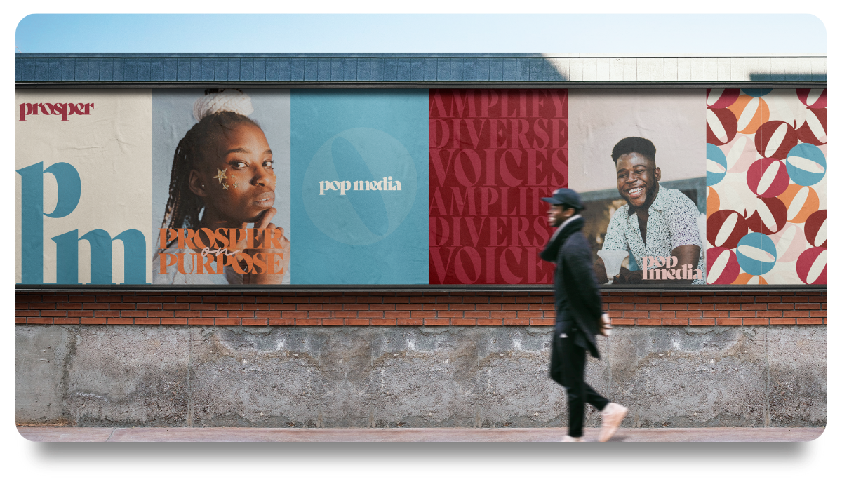 An outdoor wall with multiple large posters featuring diverse people and text promoting 'Prosper Purpose', 'diversity', and 'voices'. A person in a black coat and hat walks past the posters. Studio Wellmade