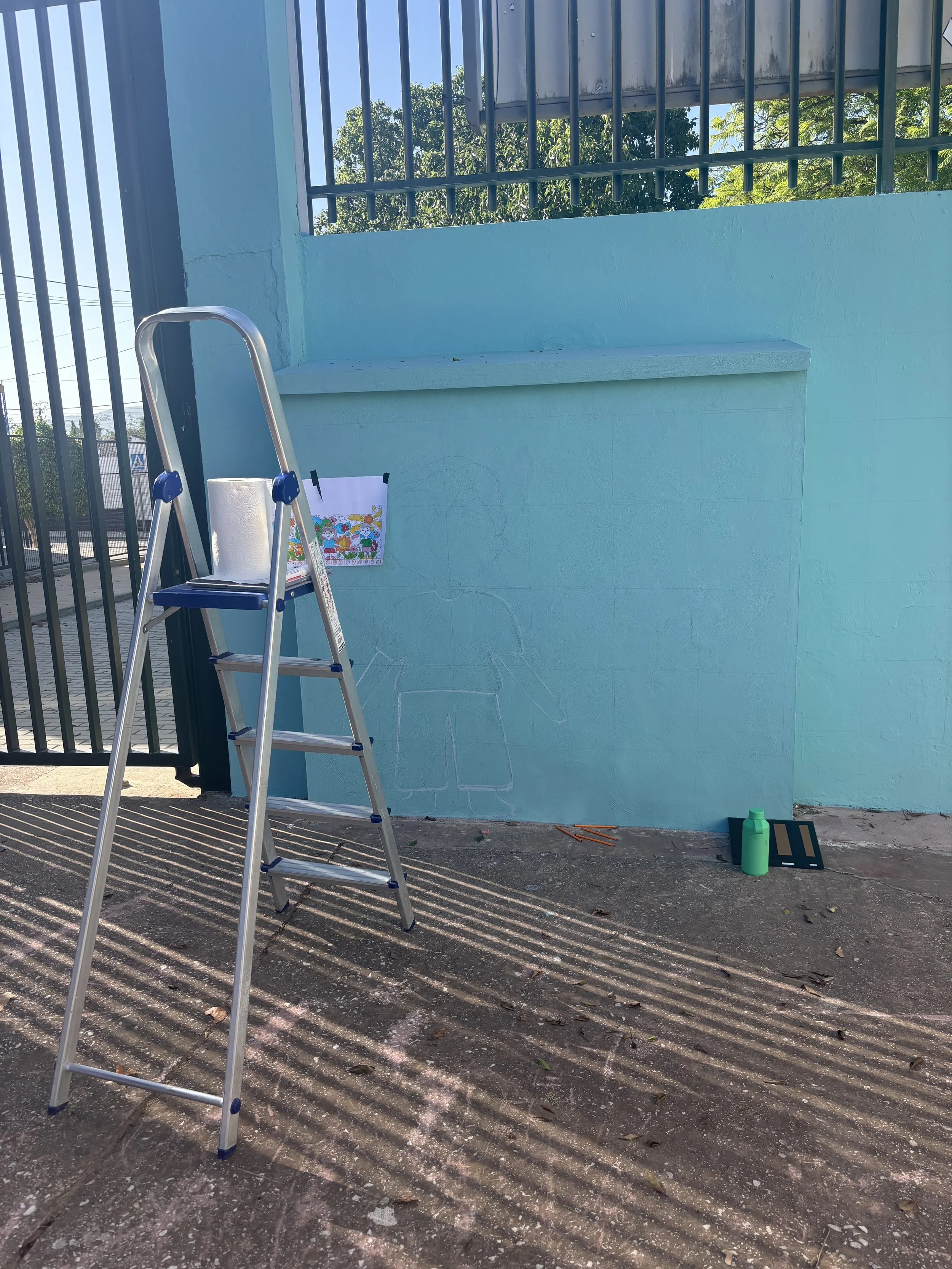 Before starting any design for the mural, it's essential to measure the wall multiple times to ensure you have the correct measurements. Even though we did this, we realized, as we were gridding the mural, that the wall itself was at a significant sl