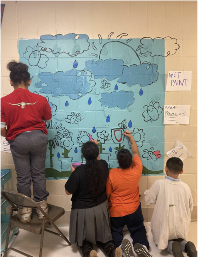 Step 3: Students in 4th and 5th grade painted the mural, adding the school motto to the clouds. 
