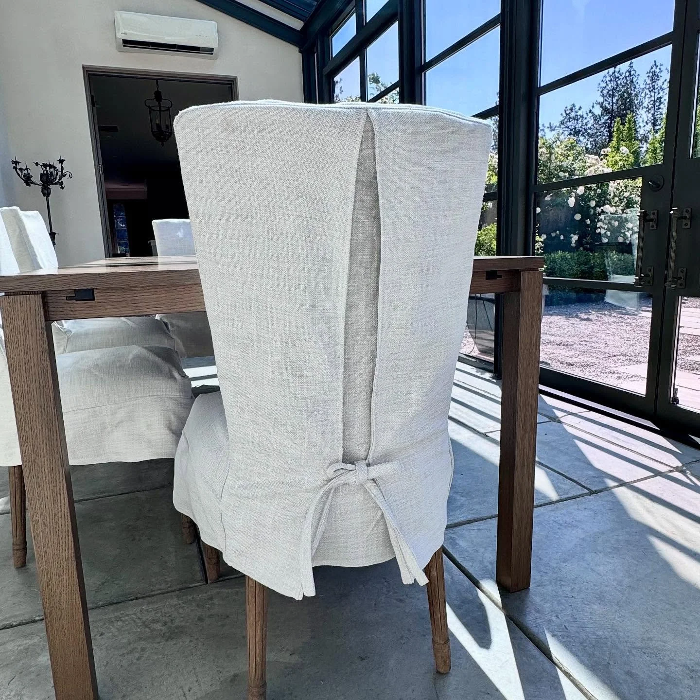 Lined Sunbrella dining chairs with ties. These were a necessity for this client. She moved into a beautiful home where her dining room was a sun room. Beautiful!  #customslipcovers #slipcovers #Spokaneslipcovers #homedecor #furnituremakeover #upholst