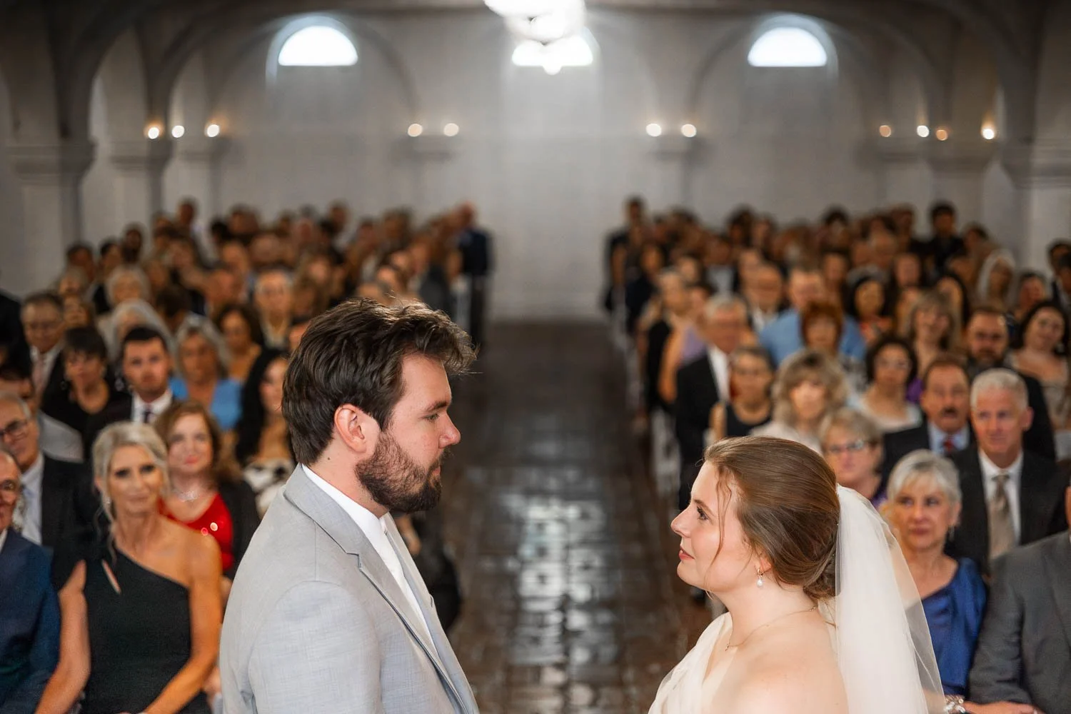bride and groom face each other during wedding ceremony at the boo cat club - missouri wedding photographers