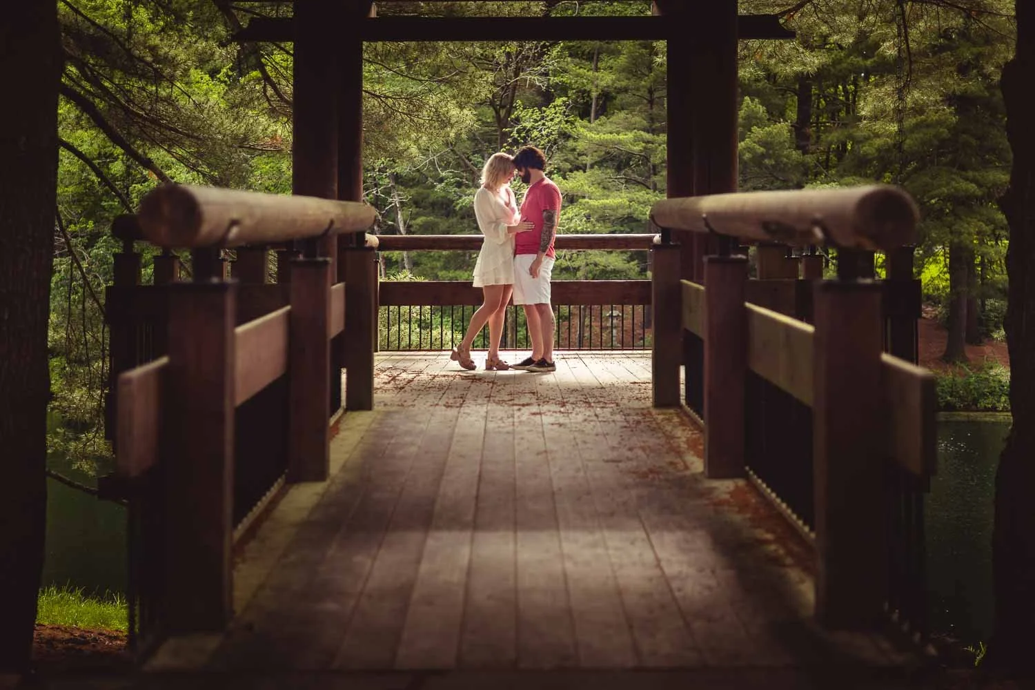 engaged couple snuggling on bridge overlooking lake-illinois engagement photographer