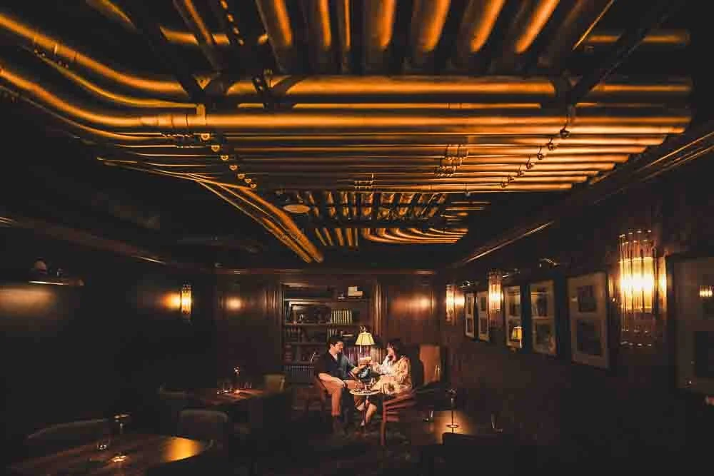 couple sitting in a speakeasy having drinks-josh and lindsey photo
