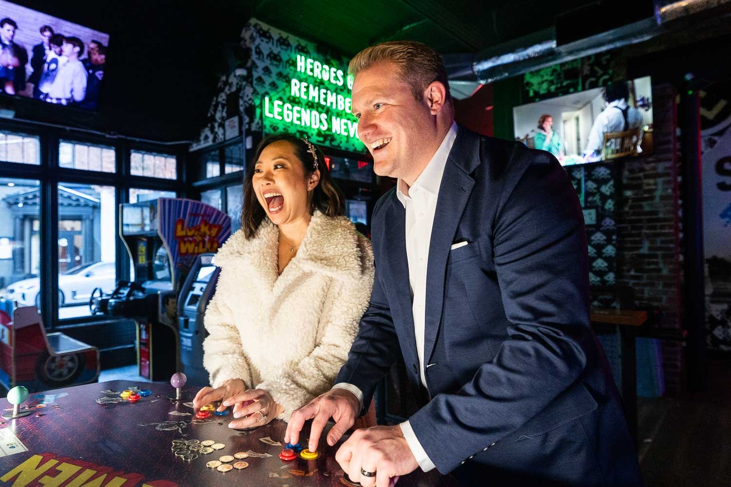 wedding couple play video games in downtown st louis mo-documentary wedding photography