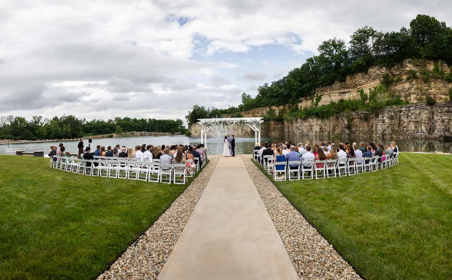 Bride and groom getting married in front of Sunset Bluffs Wedding Venue