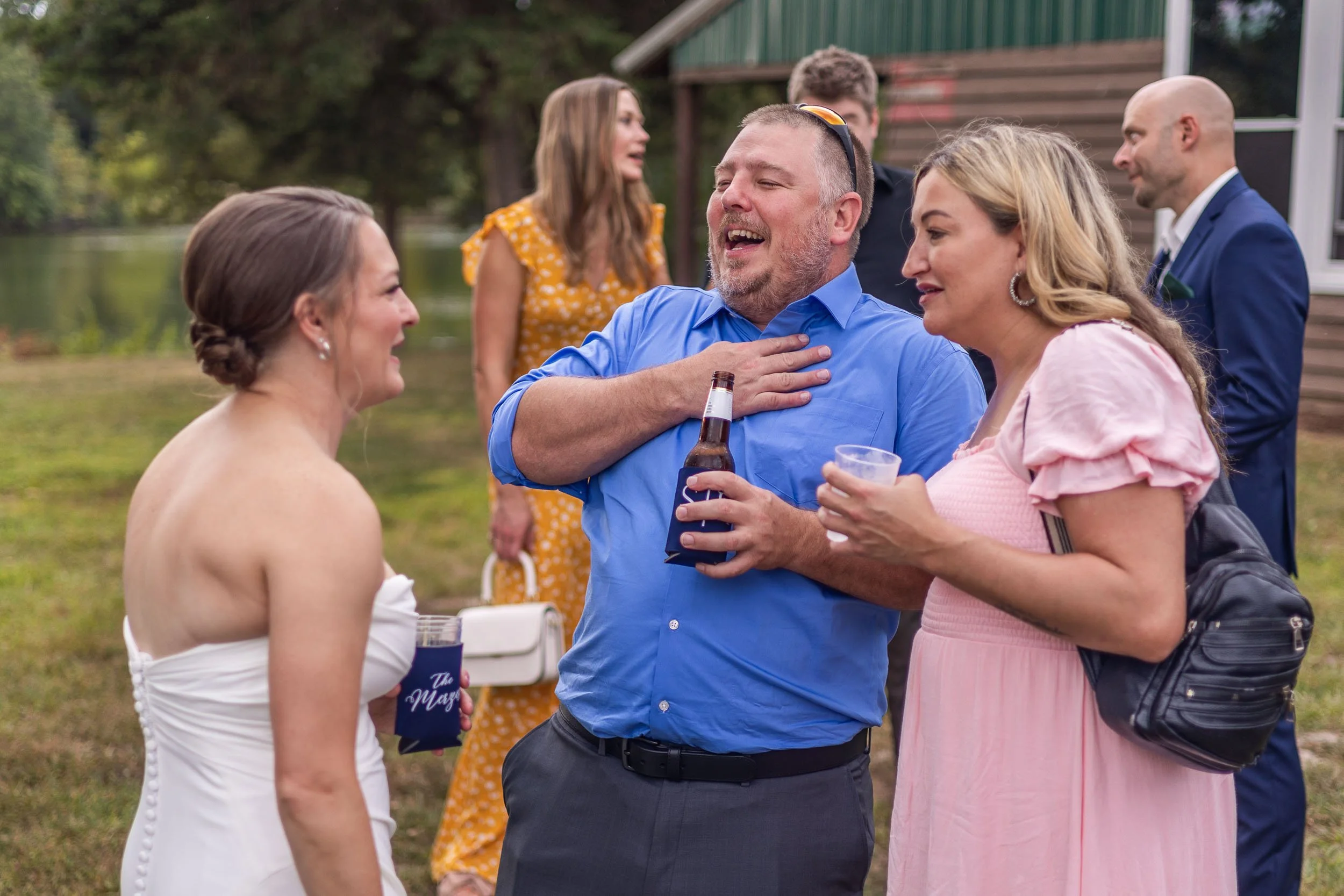 wedding guests laughing with bride during wedding reception_Western Illinois