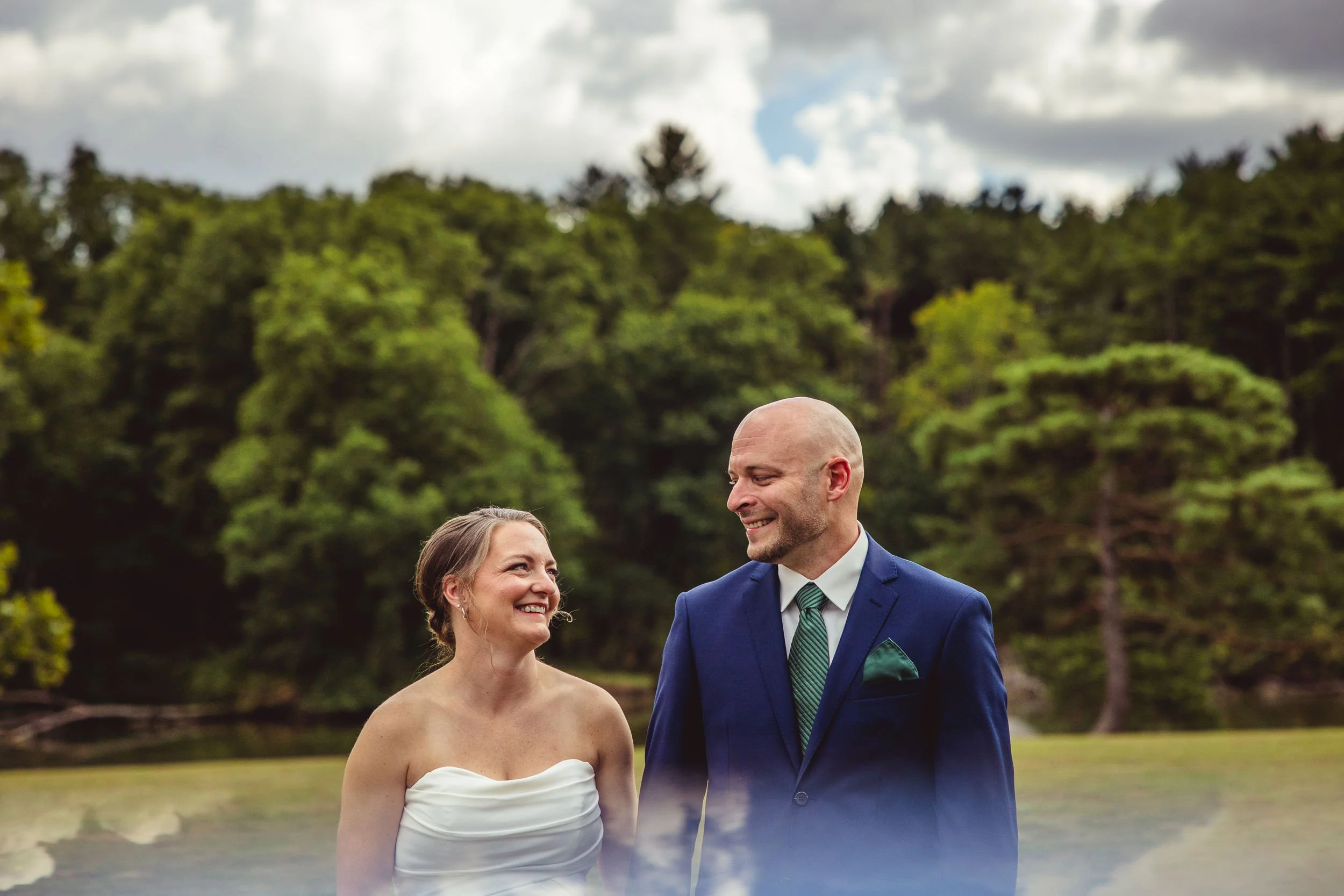 Western Illinois_bride and groom first look in an open field and blues skies and white clouds