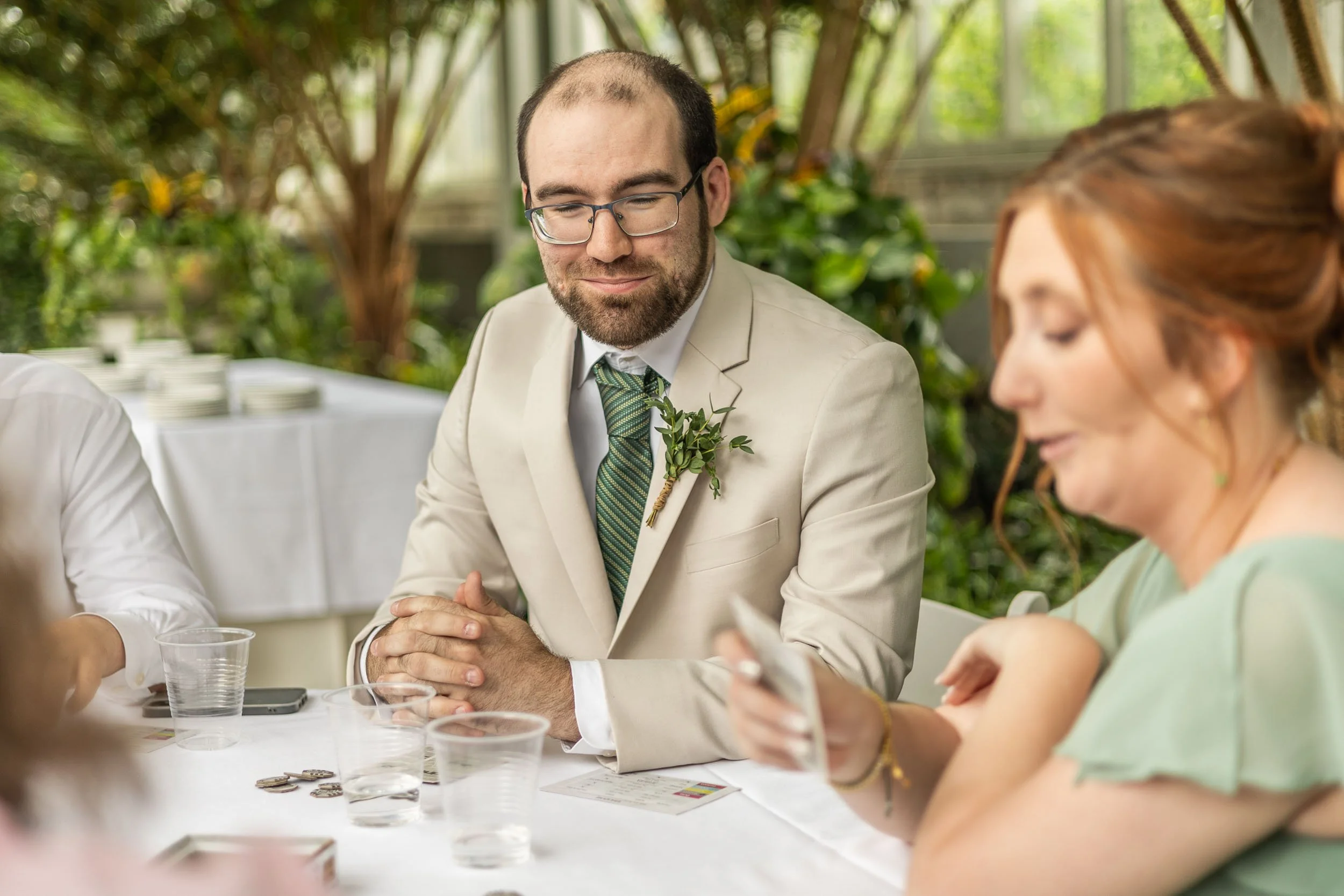 groomsman playing board game at wedding at jewel box in forest park