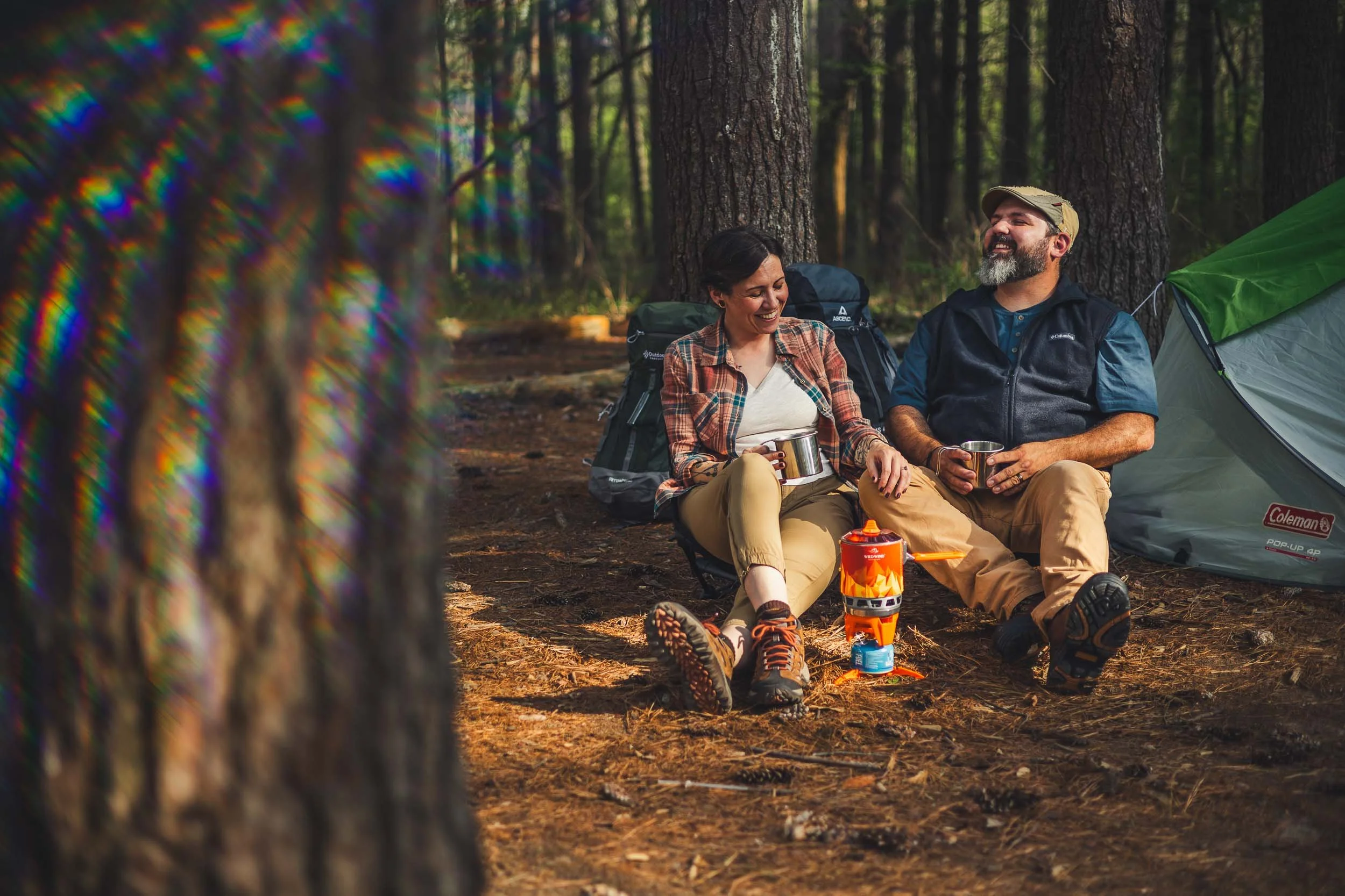 couple laughing around camp fire_busch wildlife engagement session