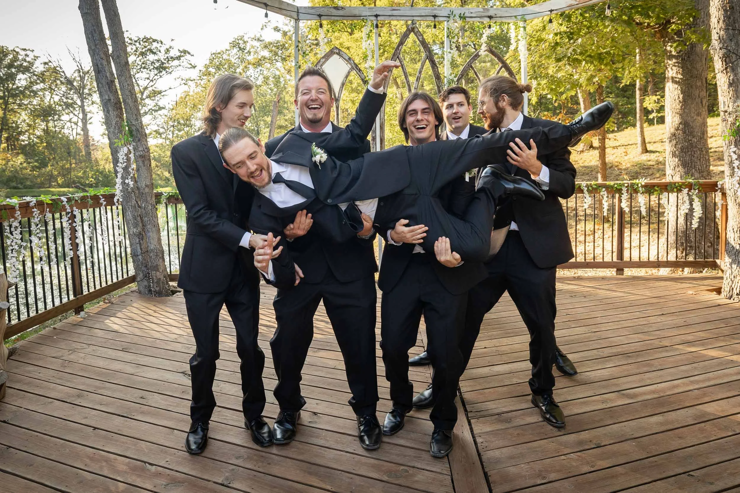groom being lifted in the air by groomsmen_St Charles documentary wedding photography