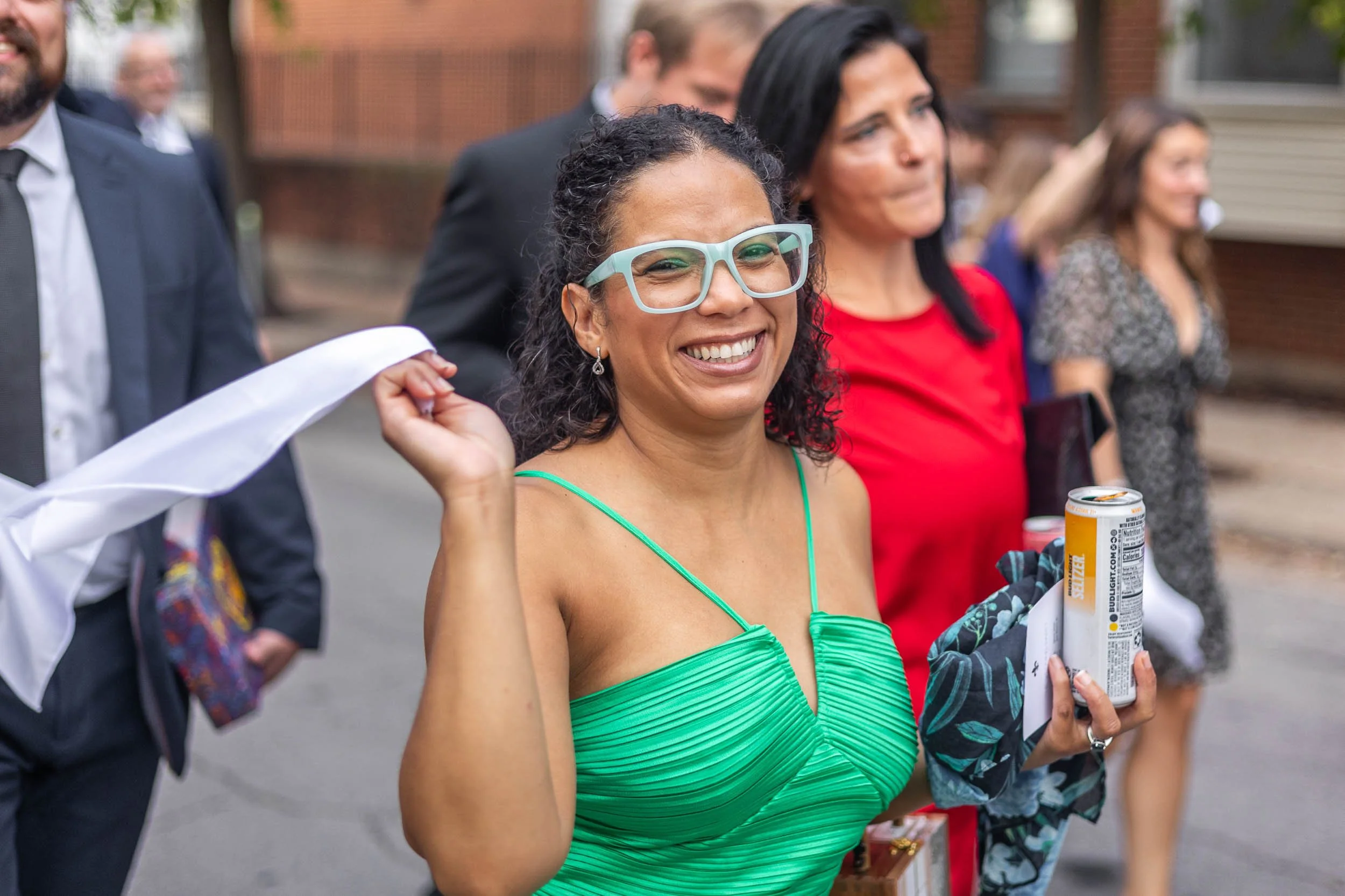 wedding guest walking with bride and groom during second line