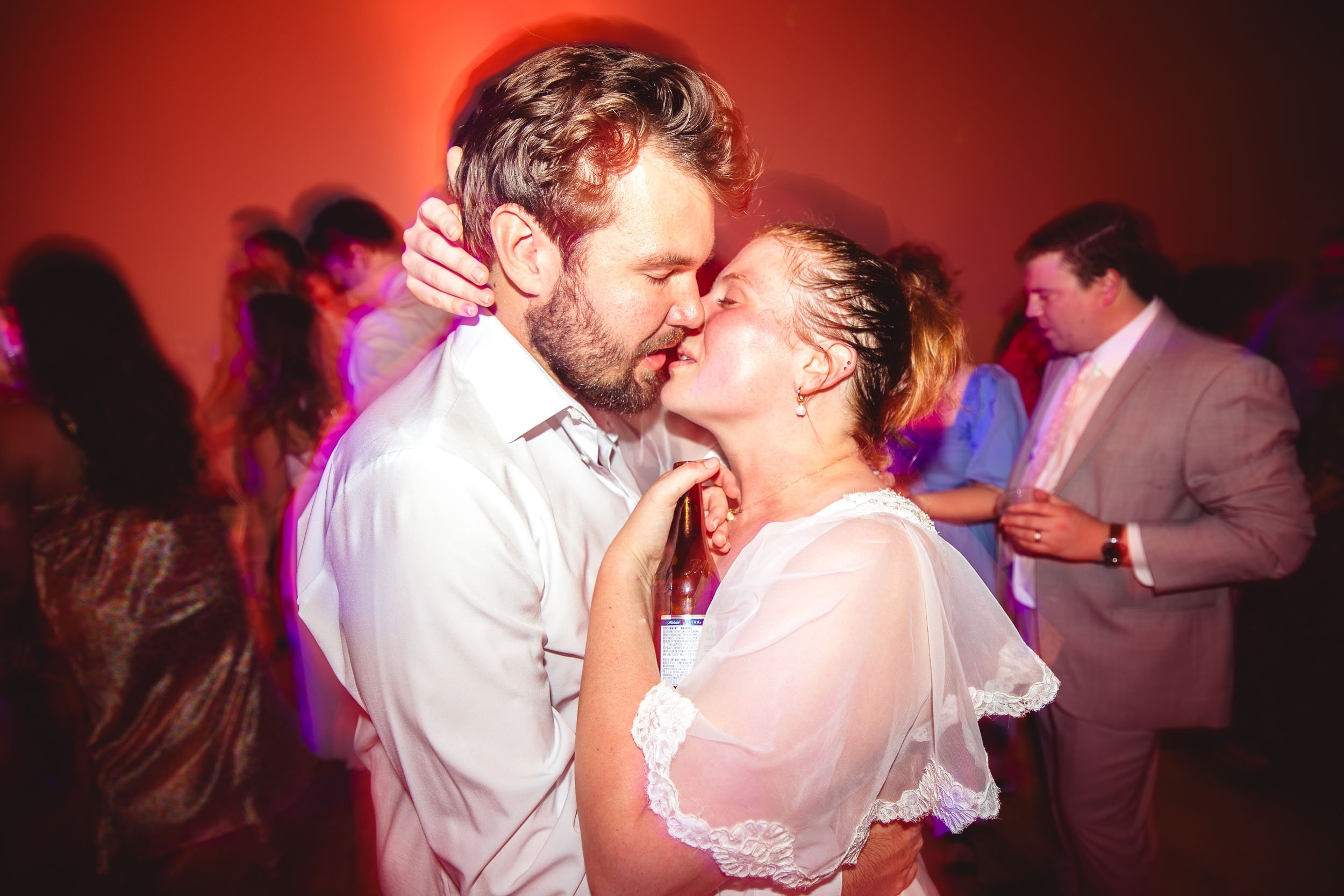 bride and groom passionately kissing