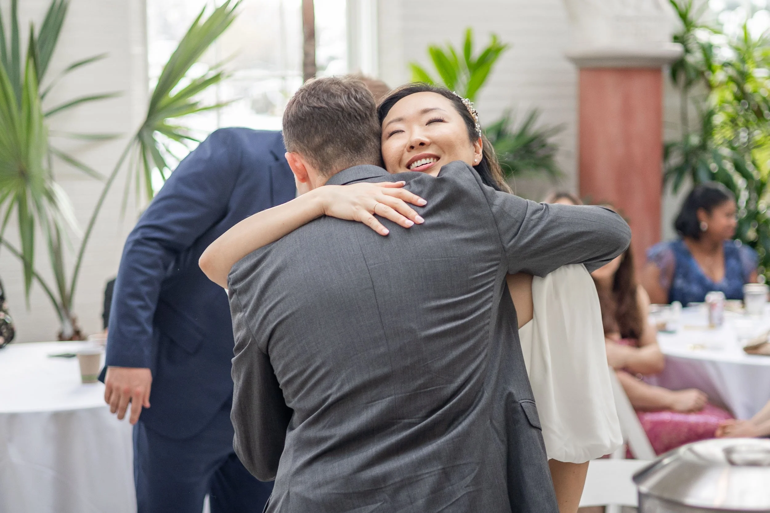 bride-hugging-wedding-guest-documentary-photography.jpg
